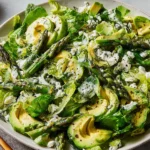Green Goddess Salad Recipe served with asparagus, avocado slices, feta, and herb yogurt dressing