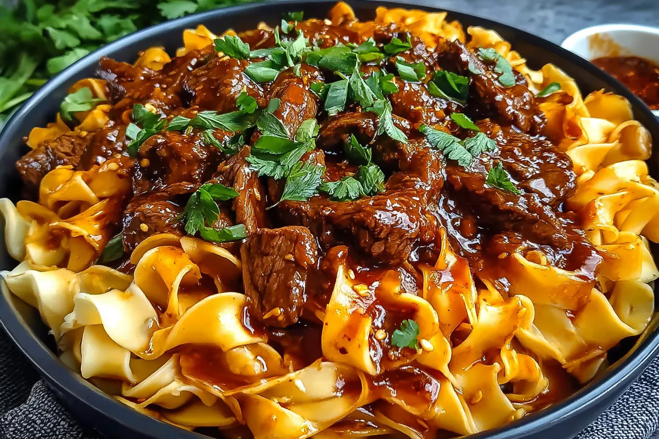 Korean Beef Noodles with tender beef chunks, silky noodles, and a savory sauce garnished with fresh herbs