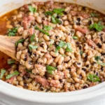 Slow Cooker Black-Eyed Peas Recipe showing tender peas and bacon scooped from the crockpot