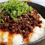 Ground Beef Hot Honey Bowl served over fluffy white rice, topped with green onions and sesame seeds, with a glossy sweet-spicy beef sauce.
