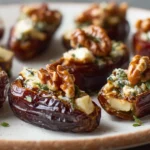Air Fryer Brie Stuffed Dates served on a white plate with honey drizzle and herbs