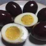 Balsamic Pickled Egg Recipe with sliced egg showing creamy yolk and dark exterior