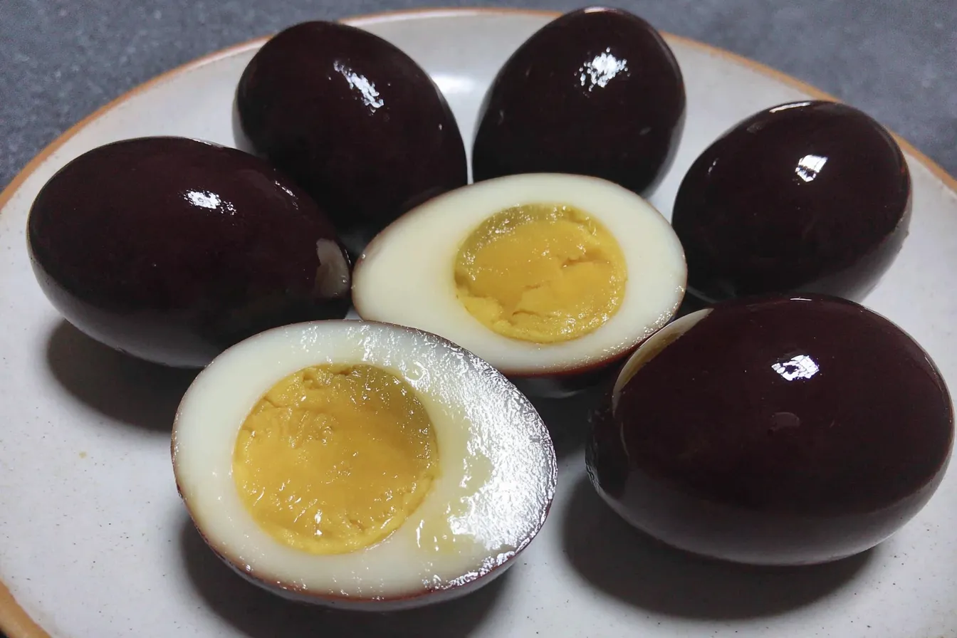 Balsamic Pickled Egg Recipe with sliced egg showing creamy yolk and dark exterior