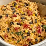 Creamy Southwestern Chicken Salad with black beans, corn, red bell pepper, and shredded chicken in a white bowl