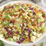 Crunchy Detox Salad with chopped broccoli, cauliflower, cabbage, carrots, almonds and raisins in lemon ginger vinaigrette