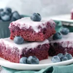 Stacked Glazed Blueberry Brownies Recipe bars with creamy glaze and juicy blueberries on top