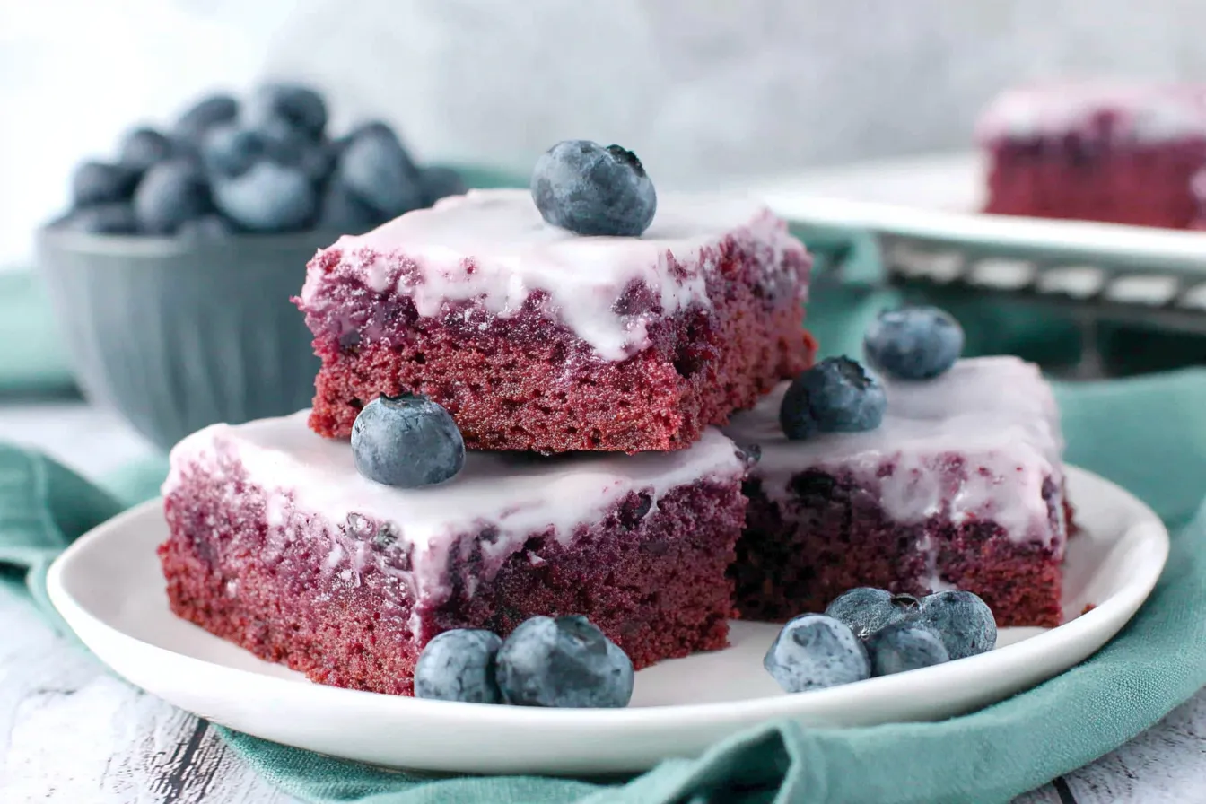 Stacked Glazed Blueberry Brownies Recipe bars with creamy glaze and juicy blueberries on top