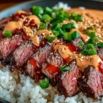 Close-up of Korean BBQ Steak Rice Bowls with juicy sliced steak, jasmine rice, spicy sriracha cream sauce, sesame seeds, and fresh green onions