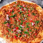 Lahmacun Recipe Baked Turkish Pizza served family-style with crispy edges, minced meat topping, and fresh herbs
