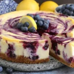 Lemon Blueberry Cheesecake with creamy lemon filling, graham cracker crust and fresh blueberry swirl