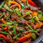 Homemade Mongolian Beef with bell peppers and green onions served with steamed rice