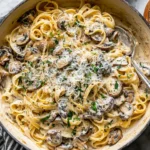 Mushroom Cream Sauce Pasta in skillet with fettuccine and creamy garlic mushroom sauce