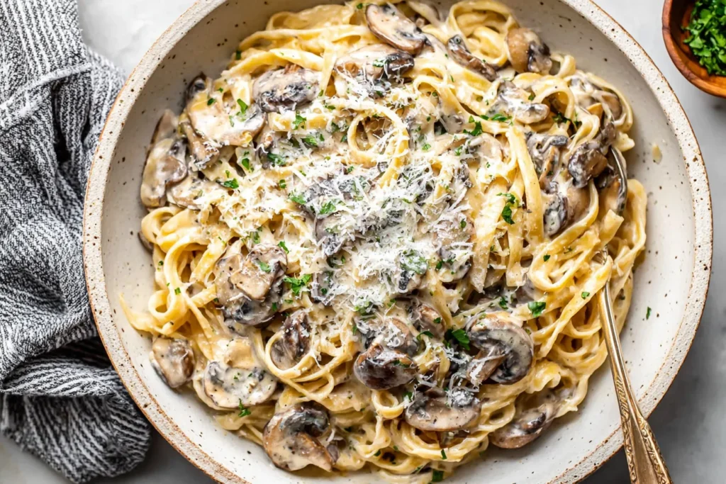 Mushroom Cream Sauce Pasta in a bowl with creamy parmesan sauce and sautéed mushrooms