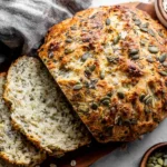 No Knead Seeded Oat Bread sliced to show soft, hearty crumb with oats and seeds