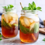 Simple Honey Mint Green Iced Tea in mason jars with fresh mint leaves and ice cubes