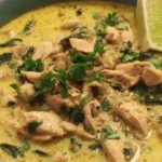 Slow-Cooked Thai Ginger Chicken Soup with shredded chicken and creamy coconut broth