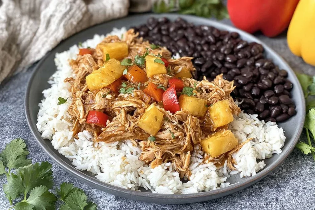 Slow Cooker Caribbean Jerk Chicken served over fluffy white rice with black beans, pineapple chunks, and bell peppers, garnished with cilantro.