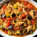 Slow Cooker Ratatouille with Chicken in a white bowl—shredded chicken with zucchini, eggplant, peppers, and tomatoes in a savory slow-cooked sauce.