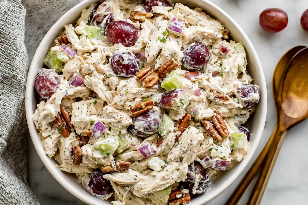 Sonoma Chicken Salad with grapes, pecans, celery, and creamy poppy seed dressing in a white bowl