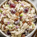 Sonoma Chicken Salad with grapes, pecans, celery, and creamy poppy seed dressing in a white bowl