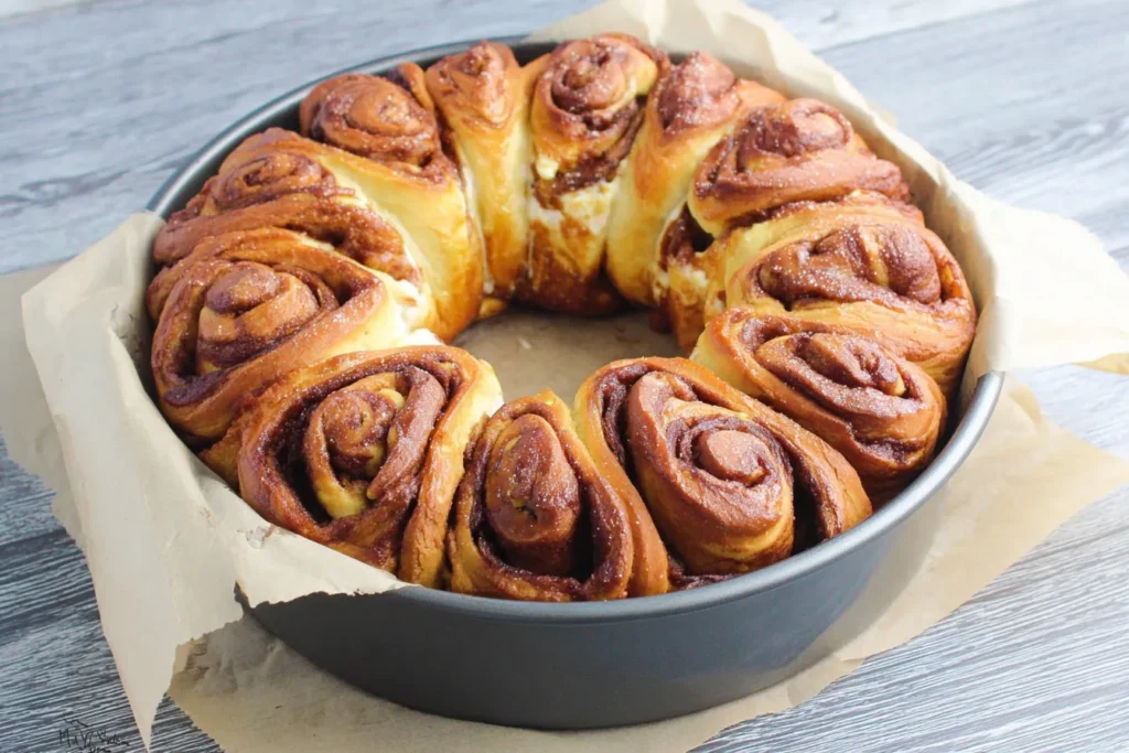 Easy King Cake Recipe – Cinnamon Roll King Cake before frosting in round baking pan