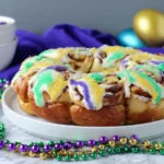 Easy King Cake Recipe – Cinnamon Roll King Cake with purple green and gold Mardi Gras icing