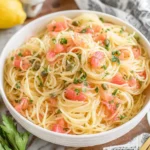 Close-up of Lemon Capellini Salad with angel hair pasta, chopped parsley, tomatoes, and capers