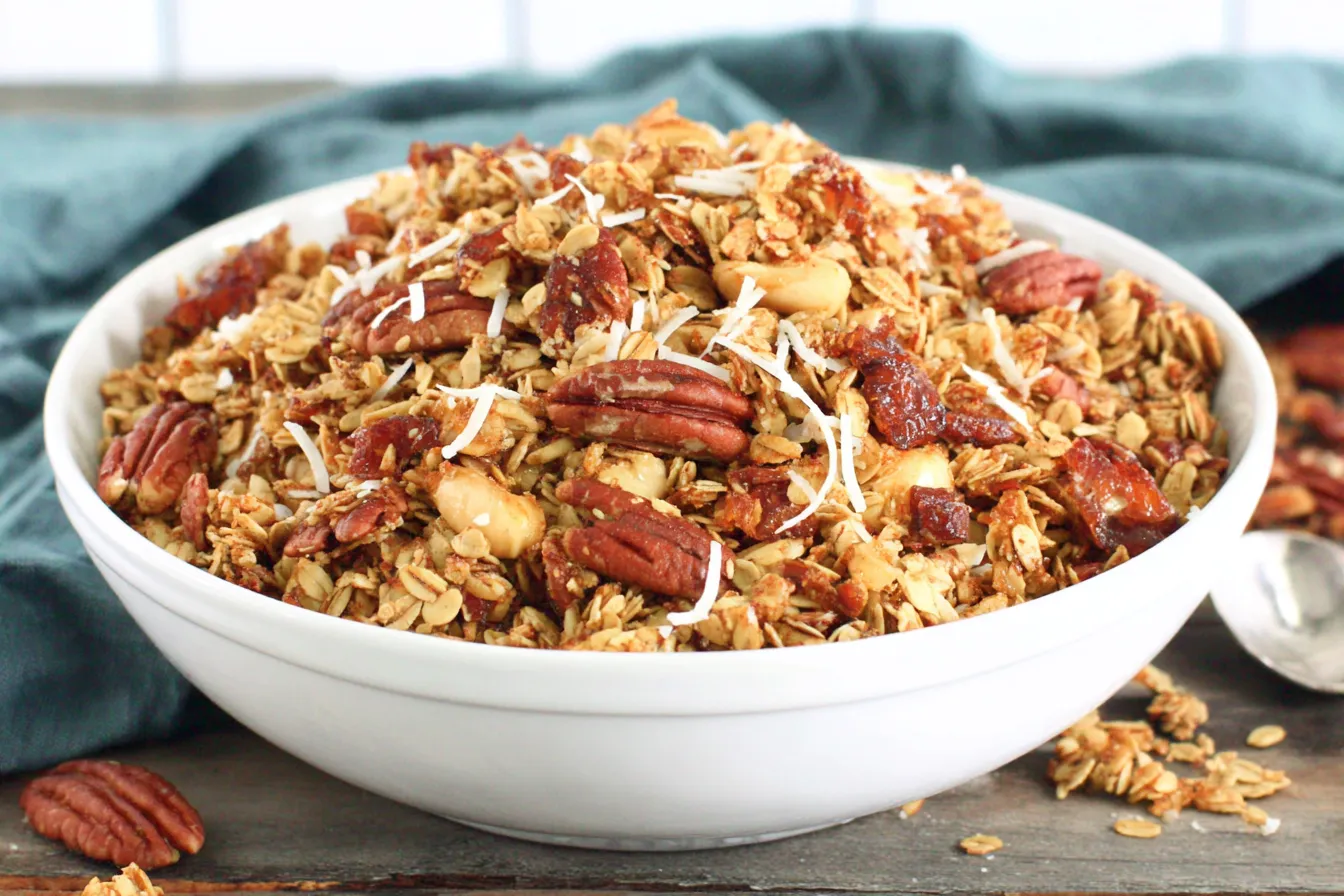 Slow Cooker Granola served in a bowl with toasted oats, pecans, coconut flakes, and dried fruit
