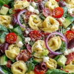 Colorful Tortellini Pasta Salad with mozzarella, salami, vegetables, and herbs