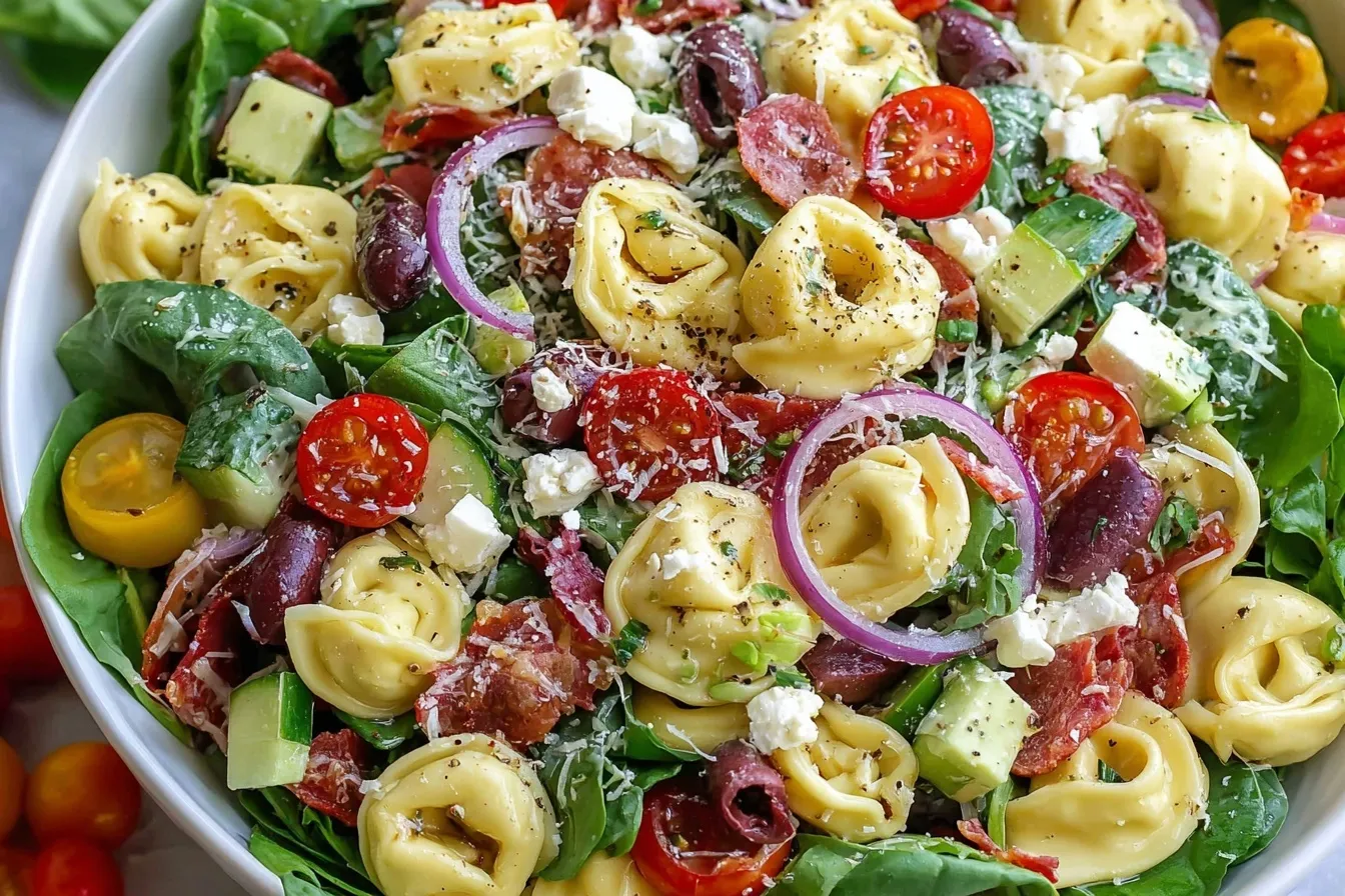 Colorful Tortellini Pasta Salad with mozzarella, salami, vegetables, and herbs