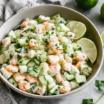 Cucumber Shrimp Salad served in a bowl with diced cucumber, tender shrimp, fresh herbs, and lime wedges—creamy, bright, and refreshing.