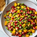 Mango Strawberry Avocado Edamame Salsa in a large bowl with tortilla chips—mango, strawberries, edamame, red onion, herbs, and lime dressing.