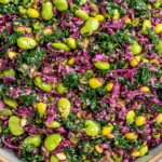 Longevity Miso Bowl with kale, red cabbage, edamame, sesame seeds, and fresh herbs in a zesty miso-ginger dressing
