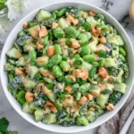 Cucumber Edamame Salad with creamy miso dressing, chopped cucumbers, edamame, cashews, green onions, and extra dressing on the side