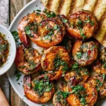Pan Seared Chimichurri Shrimp with juicy seared shrimp, fresh herb sauce, red pepper, and grilled bread on a white serving plate