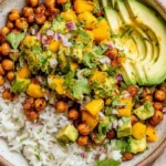 Protein-packed bowl of Mango Chickpea Salad with crispy chickpeas, fluffy rice, creamy avocado slices, and fresh cilantro-lime mango salsa.